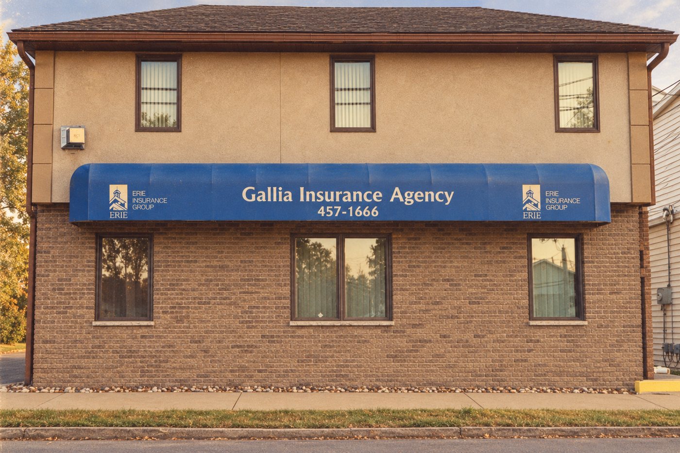 The Gallia Insurance Agency office, a two-story brick building with a blue awning